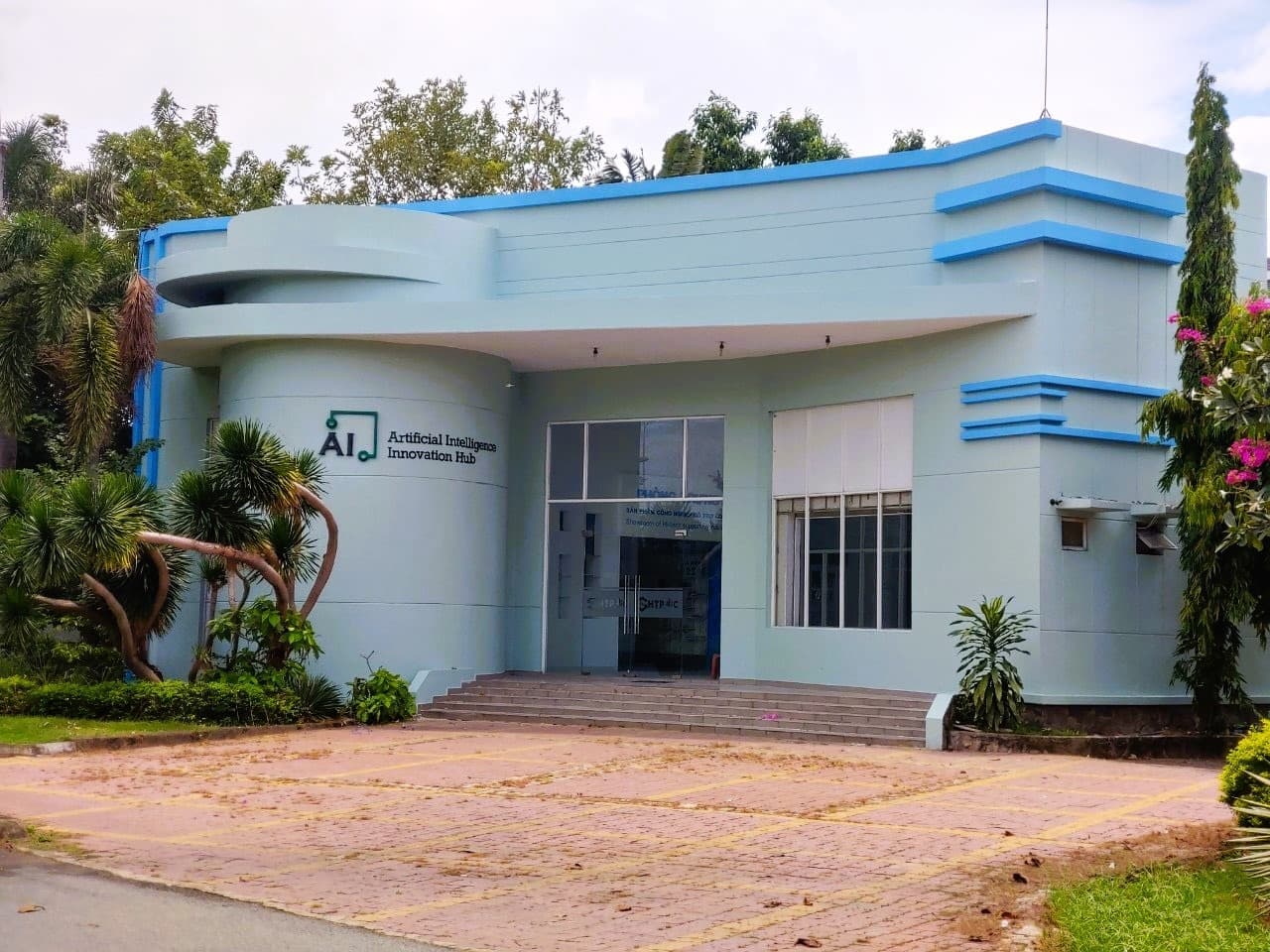 AI Innovation Hub exterior with four team members standing and smiling in front